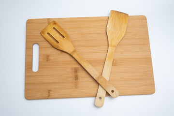 Bamboo Cutting Board with Spatulas on White Background