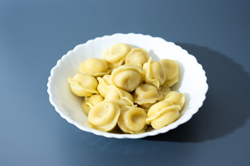 Dumplings in White Plate on Blue Background