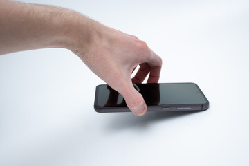 Modern smartphone in human hand on white background for technology advertisement