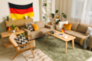 Blurred view of living room with German flags, sofas and armchair