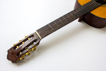 Naklejka premium A close-up photo of an acoustic classical guitar with six strings, isolated on white background.