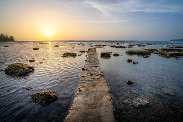 sunset on the beach with clay pathway