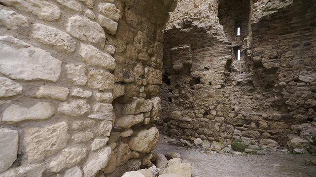 POV walk inside Bukelon Fortress near Matochina: entry, central hall, tilt to the vault, rough stone walls and narrow arrow slits. Tradition says Baldwin was held here