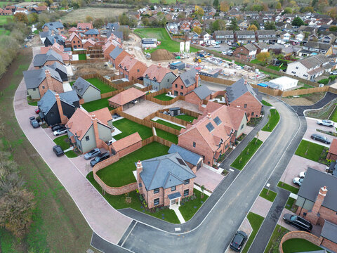Aerial view of a near completed English housing development project in rural Essex.  Both luxury detached and affordable first time buyer homes are located at the site.