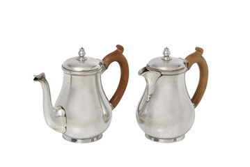 Fototapeta premium Two antique silver coffee pots with wooden handles on white background teapot creamer