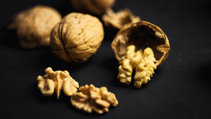 Ripe, delicious, and nutritious walnuts on a dark background. A wonderful source of vitamins, energy, and strength.