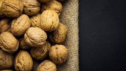 Walnuts on burlap lie on a dark background. The best source of strength, energy and vitamins for a healthy diet