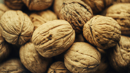 Lots of walnuts in their shells. Top view. Nutritious and delicious food.