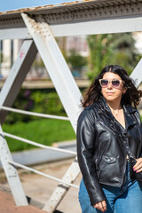 Young woman walking across an urban bridge in Malaga