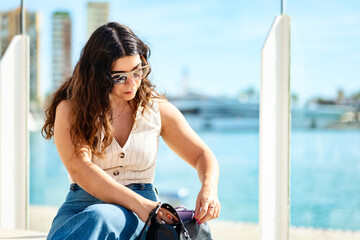 Woman searching through her bag at the port