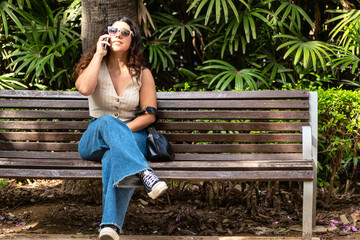 Woman talking on the phone in a park