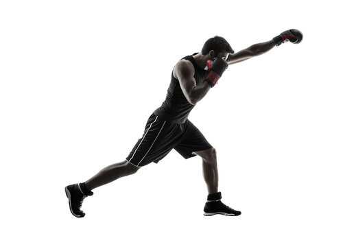 Male boxer in athletic stance executing powerful punch in silhouette with boxing gloves, isolated on a transparent background