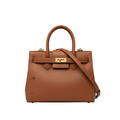 Elegant Brown Leather Handbag with Gold Buckle and Adjustable Strap Isolated on Black Background Studio Shot of a Luxurious Accessory