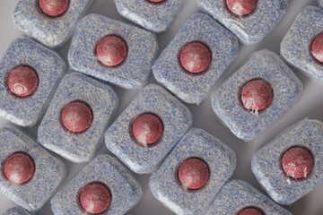 Full frame background pattern of colorful dishwasher detergent tablets and pods