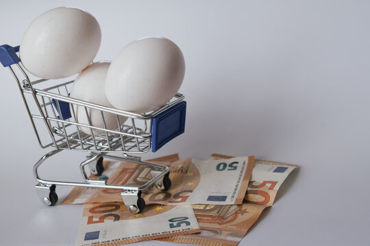 Eggs in a shopping cart with Euro banknotes, symbolizing food price inflation and cost