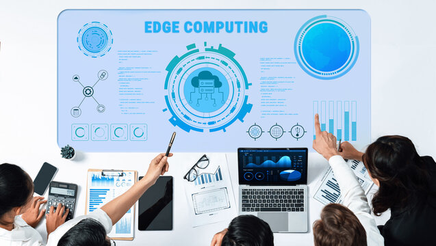 Professionals collaborate around a modern workspace focused on edge computing technology. Visual data, graphs, and tools enhance digital processing and analytics in business. Trope