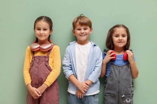 Cute little kids posing on pale green background