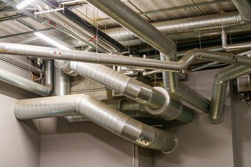 Large industrial ventilation pipes installed under the venue ceiling to provide air circulation and temperature control during concerts and events