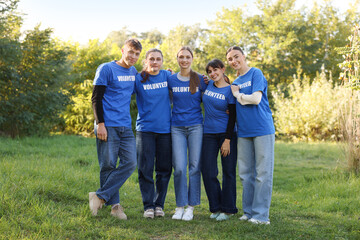 Fototapeta premium Group of happy volunteers together in park