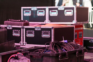 Concert gear boxes with wheels on the stage, used for transporting and protecting equipment during event setup
