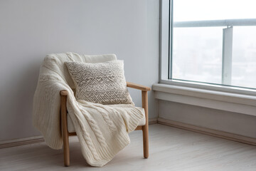 cozy thik sweater featuring intricate nordic patterns sprawled across soft inviting armchair