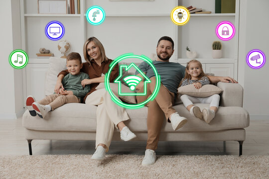 Smart home. Different icons on virtual screen and happy family in room - Powered by Adobe