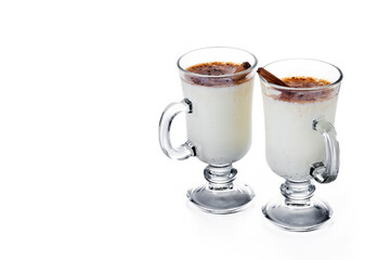 Eggnog with Cinnamon in glass isolated on white background. Christmas drink. Copy space