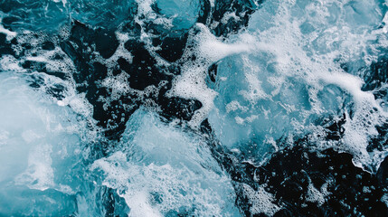Top view of ice blocks and foamy water surface with deep blue tones