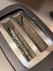 Modern stainless steel two-slot toaster viewed from above with clean metallic finish