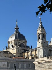 Stunning view of Almudena Cathedral with domes and spires under clear blue sky