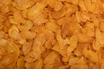 Golden cornflakes close-up background texture