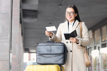 Young businesswoman with passport and ticket near airport