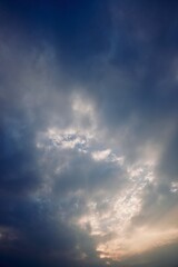 Dark moody clouds with sunlight piercing through creating contrast and depth