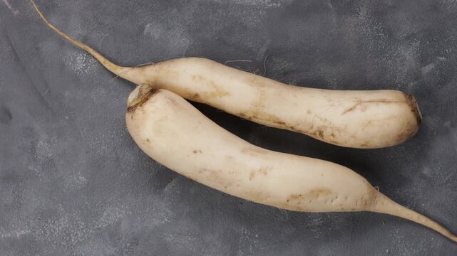roots daikon radish top view zoom grey surface