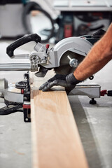 Professional handyman installing laminate flooring in a new apartment.