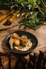 Delicious roasted chicken served on a rustic wooden table with herbs