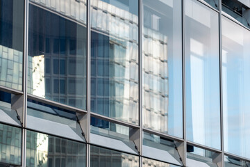 Reflection architecture emphasizing glass facade transparency in a modern urban building with smooth design pattern and clean structure geometry creating visual balance and form