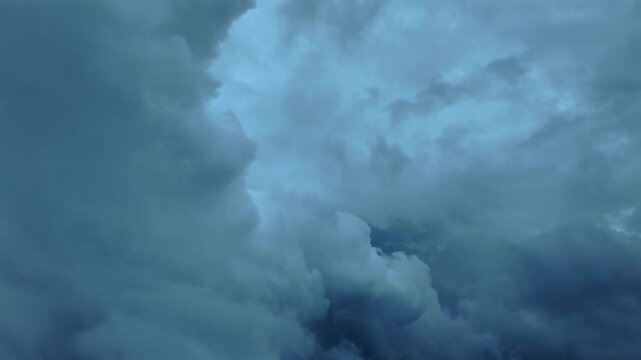 Immersive threatening experience in a flight inside storm clouds in a sinister sky full of cumulonimbus storm clouds.