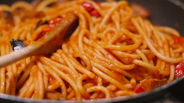 Moving Shot Over Italian Tomato Based Pasta Bucatini Spaghetti with Aubergine Egg Plant and Peppers. Delicious Cooking Close Up Food Clip.
