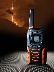 Dark thunderstorm approaching behind a handheld walkie talkie