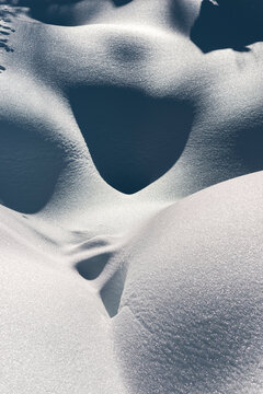 Abstract snow curves shaped by wind and winter light