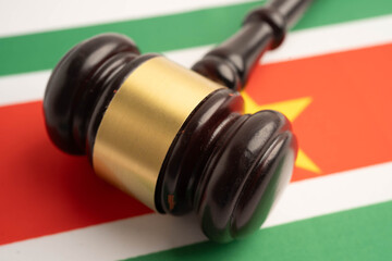 Suriname law, Legal, justice and agreement, wooden court gavel on flag.