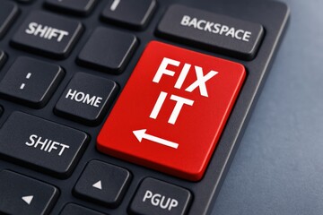 Urgent red 'FIX IT' key highlighted on a dark digital keyboard signifies crucial problem-solving, repair, and essential technical support for system issues