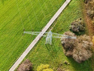 Aerial View of High Voltage Power Line Tower in Green Landscape