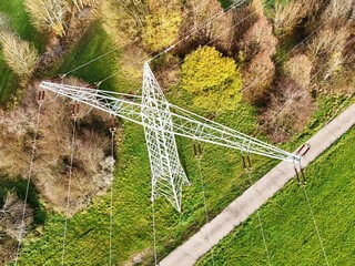Aerial View of High Voltage Power Line Tower in Green Landscape