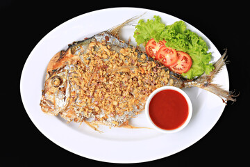 Deep-fried Diamond Trevally with Garlic, Diamond Trevally fried fish with Garlic. Food photography for use in menus
