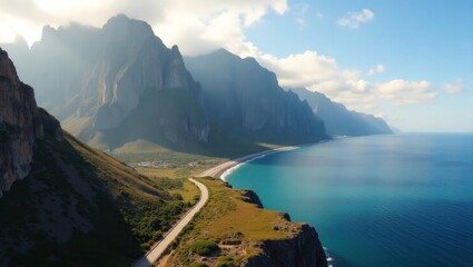 Scenic coastal road winds along a dramatic mountain range overlooking a turquoise ocean on a sunny day