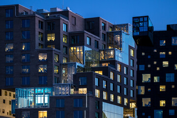 Illuminated modern architecture skyline with reflective glass facade in Oslo’s Barcode district, highlighting urban night buildings and contemporary city light perspectives