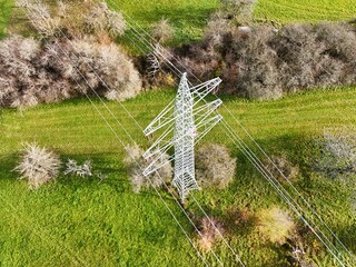 Aerial View of High Voltage Power Line Tower in Green Landscape