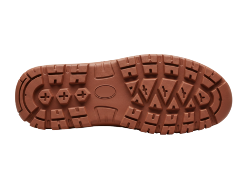 Isolated brown rubber shoe sole with tread for hiking or trekking, textured outdoor footwear
